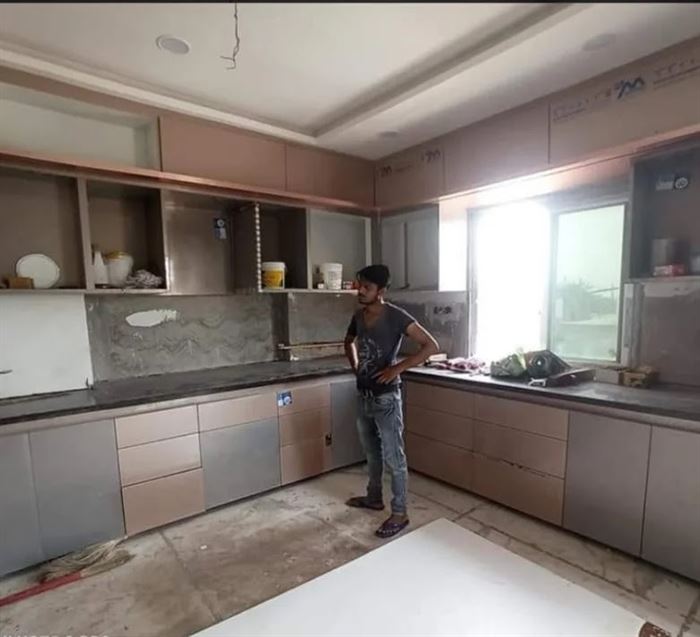 Modular kitchen with two-tone shutters and granite counter