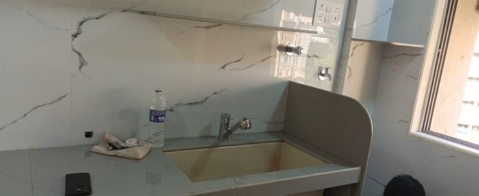 Kitchen counter with stone top and overhead units